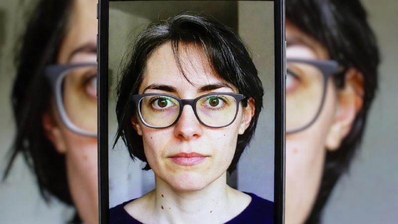 Side-by-side comparison of the same low-light urban scene shot with Tecno Phantom X, iPhone, and Samsung Galaxy, showing differences in noise, detail, and color accuracy